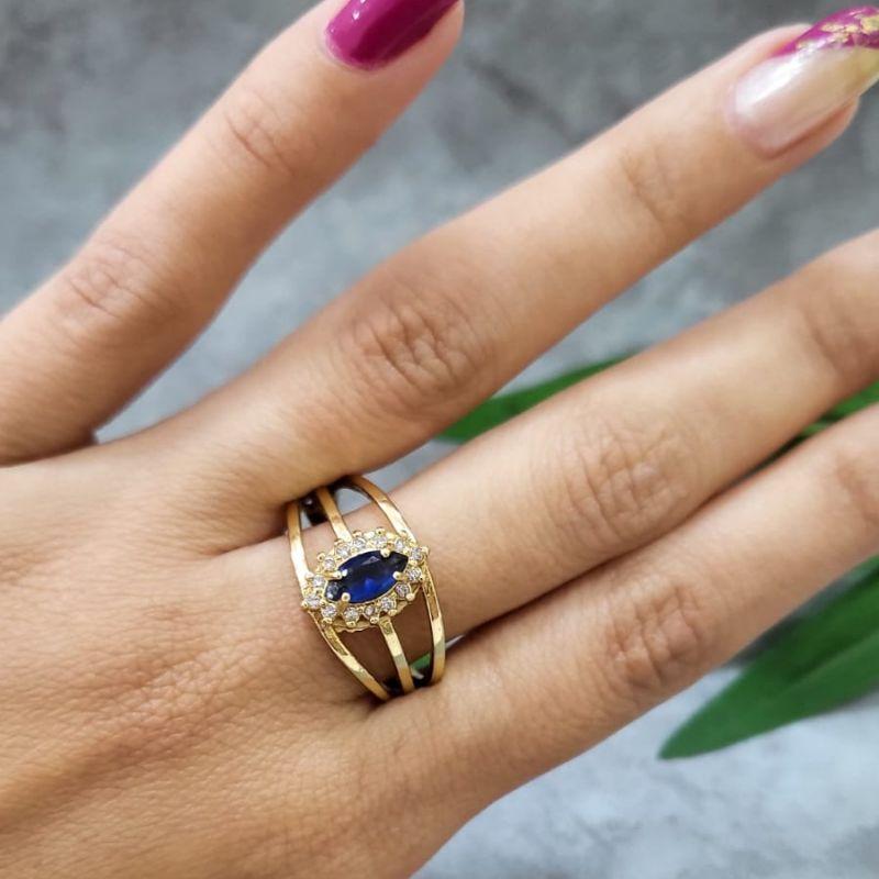 Anel de formatura feminino pedra em navete oval na cor azul bic com zirconias banhado a ouro 18k